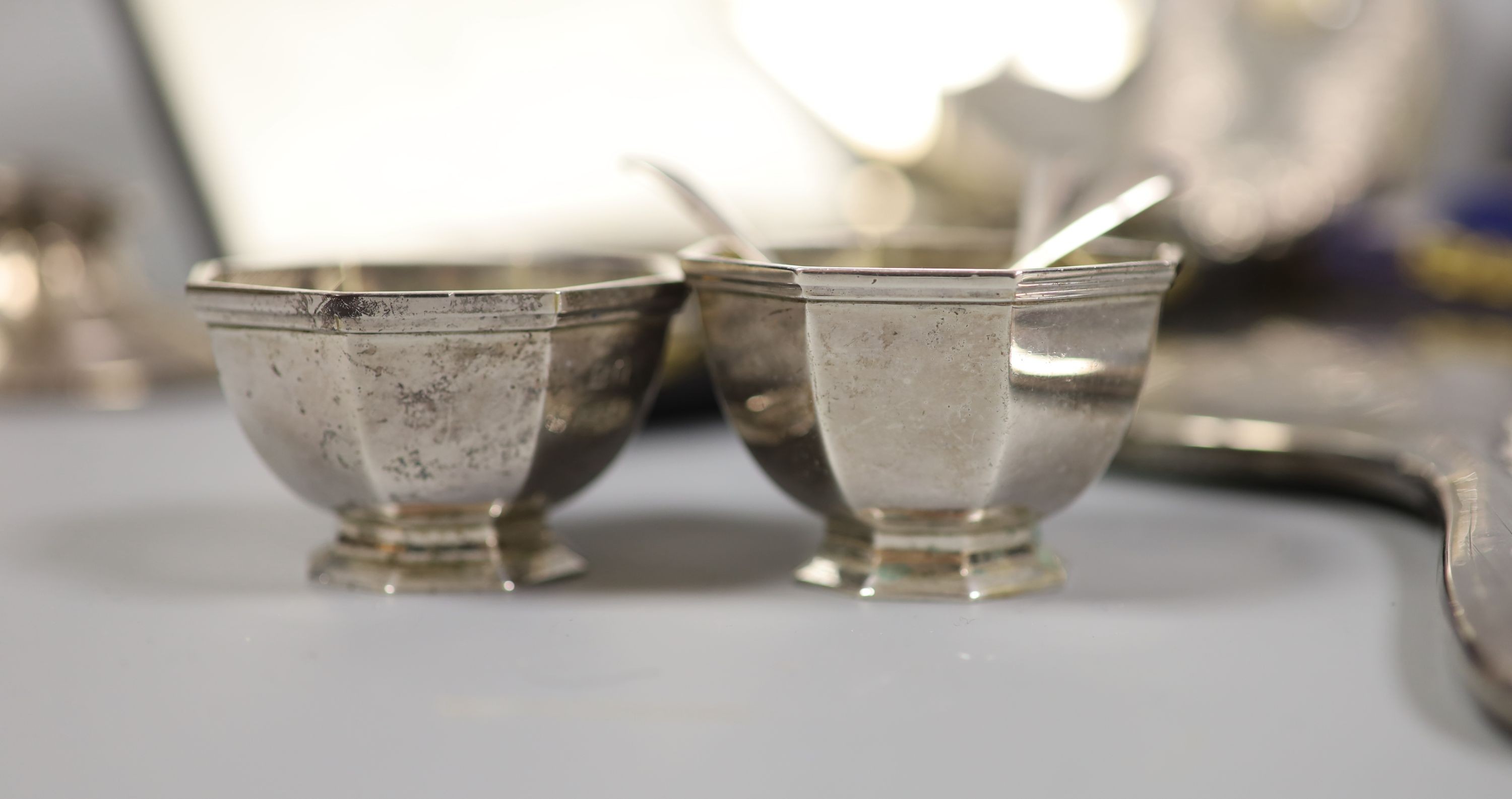 A collection of small silver including condiments, mirror and brushes, astray, cased items and a pair of sterling servers.